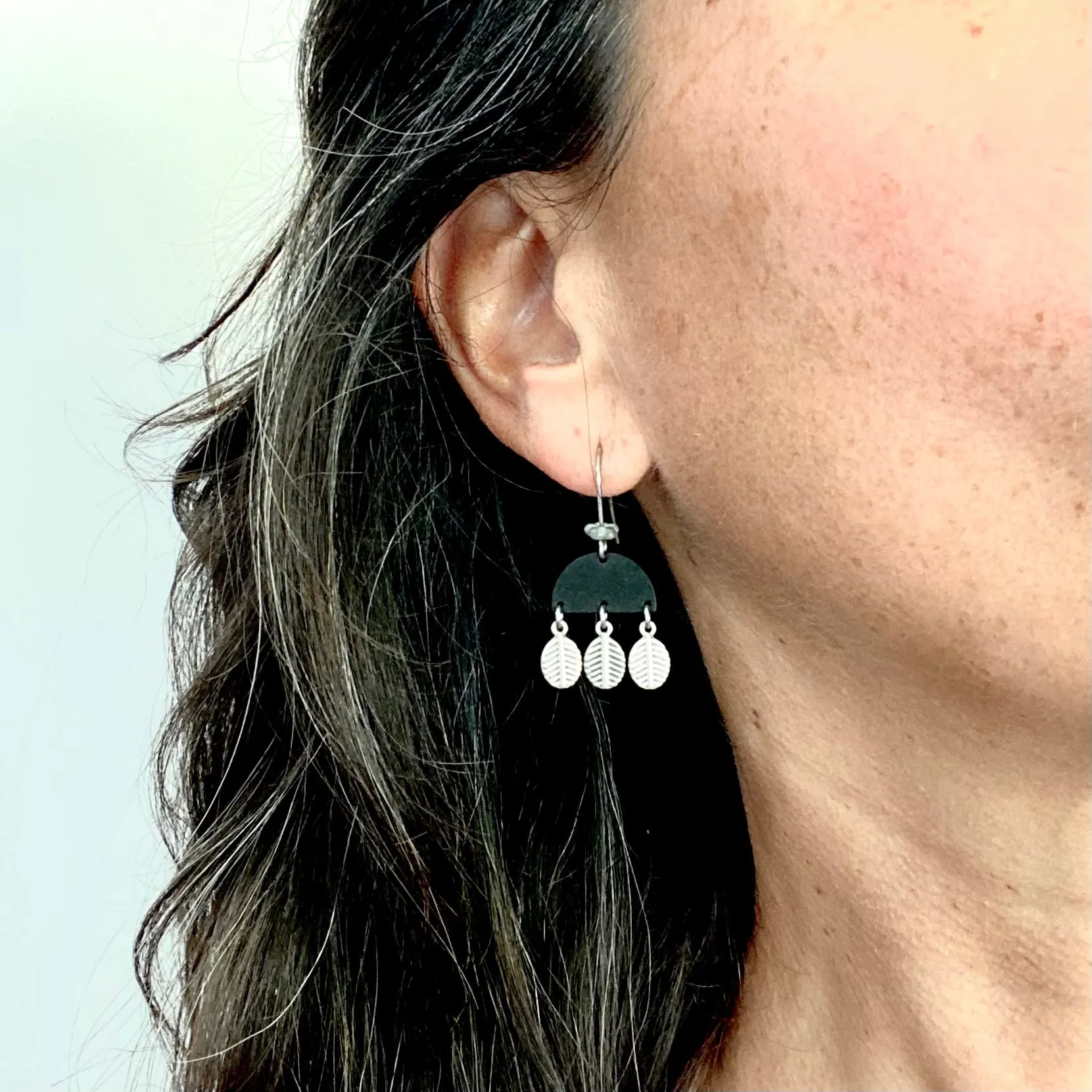 Black bell with dangly silver leaves earring